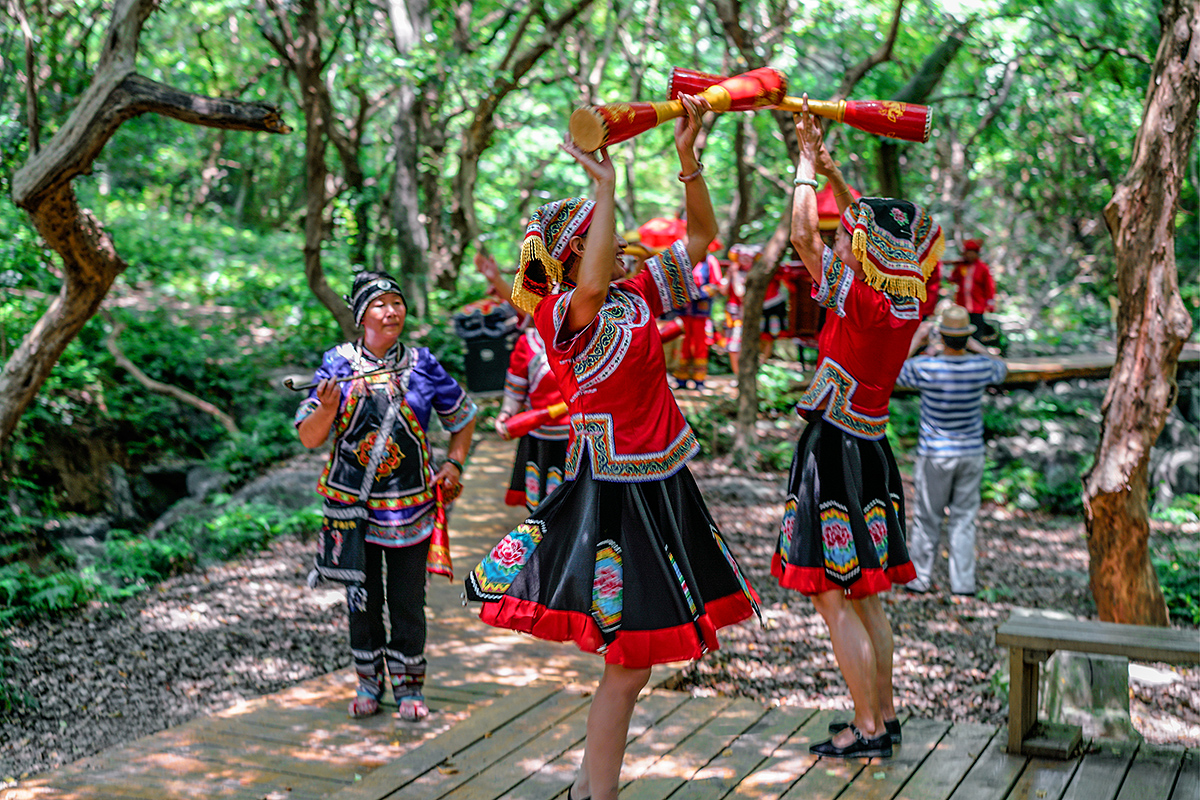 的队伍一路载歌载舞,抬着轿子前行,瑶族特色的长鼓舞是喜庆队伍的主体